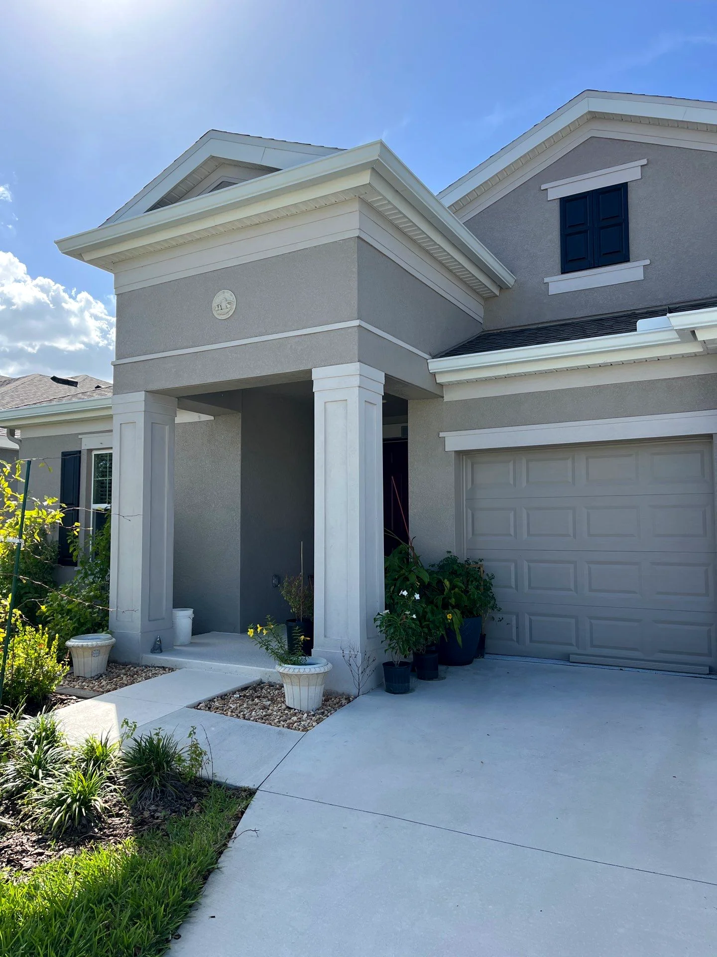 Gutter cleaning and downspout drainage on a South Florida home