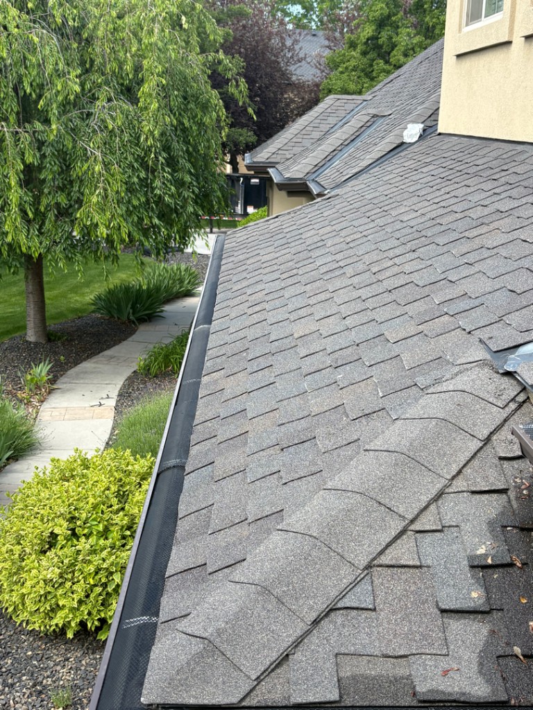 Gutter guard mesh installation along a South Florida roofline