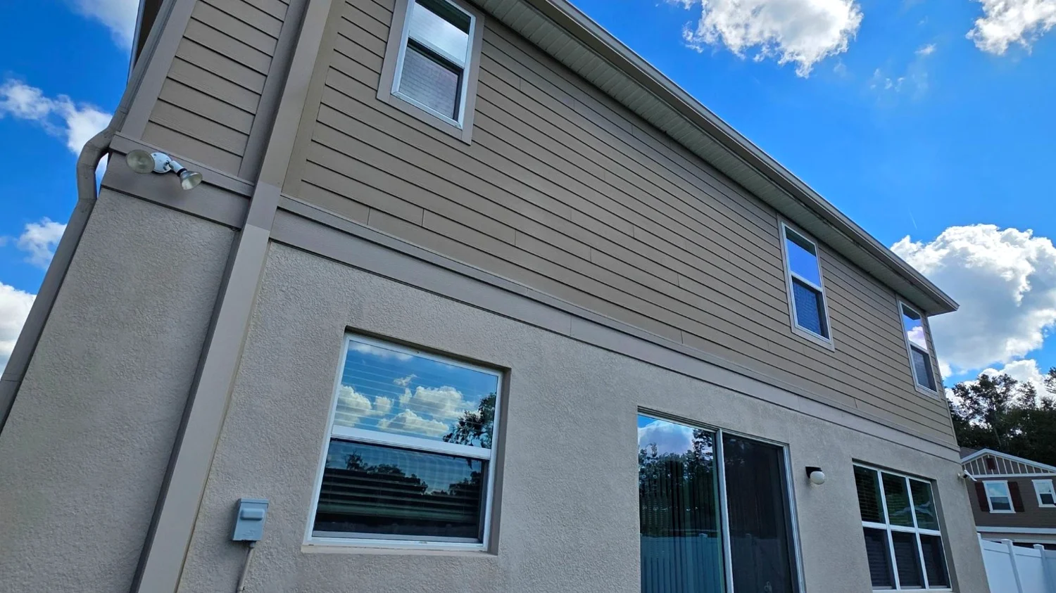 Backyard gutter installation on a home in Palm Beach Gardens