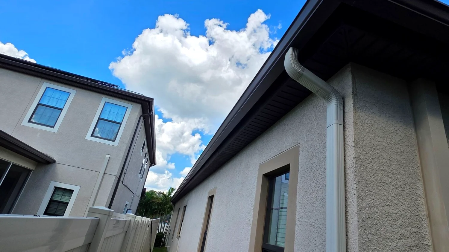 White gutters on a West Palm Beach home side yard