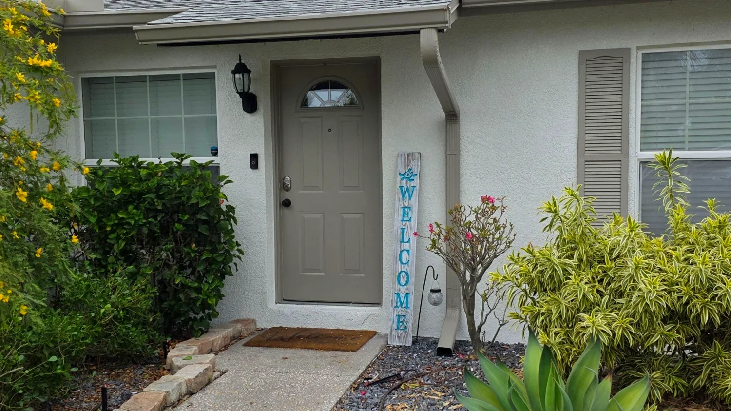 Front entry gutters and downspouts on a Brandon family home